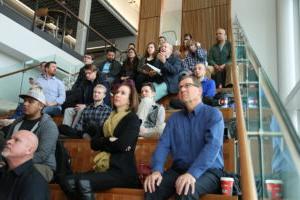 People sitting on a staircase in the AES Building for a presentation